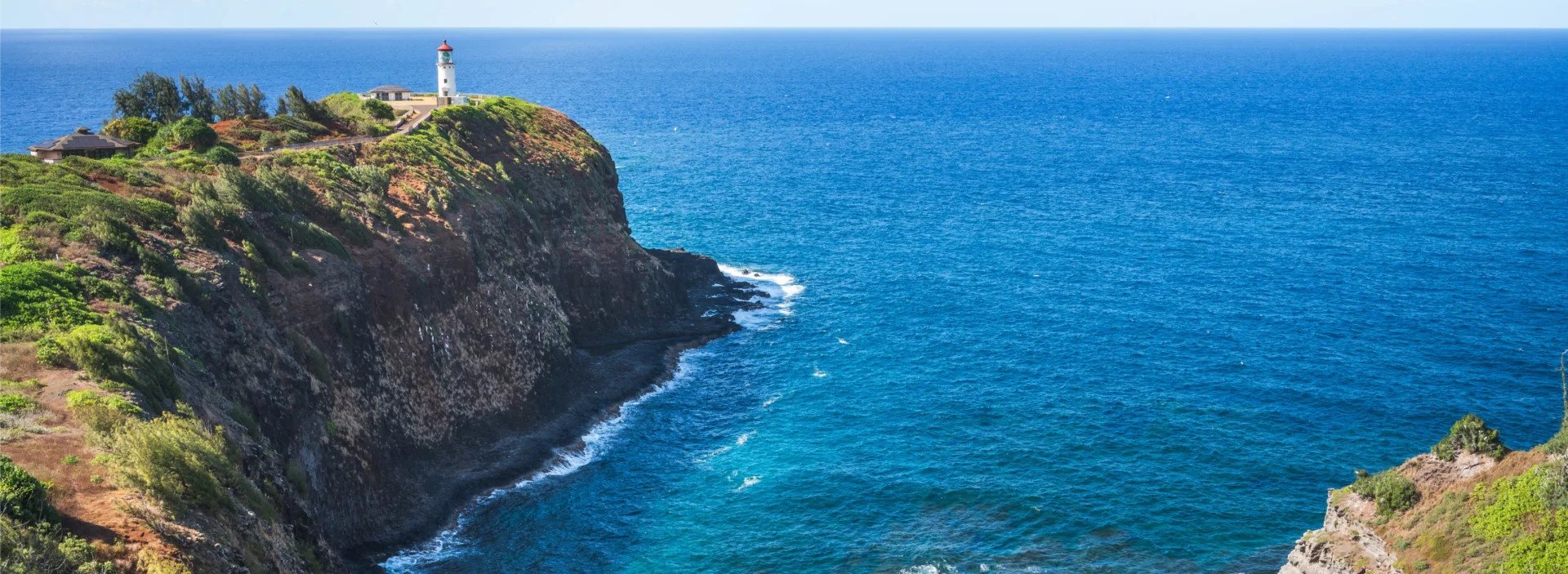 Lighthouse on a rocky coastal cliff.