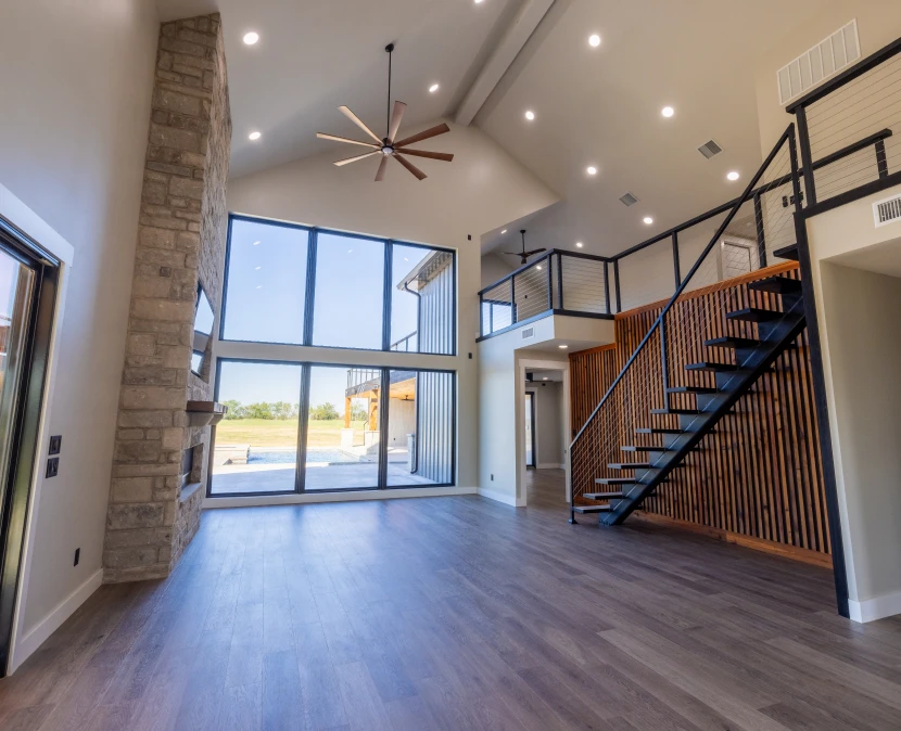 Spacious modern living room with loft stairs.