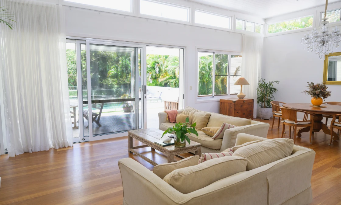 Bright living room with poolside view.